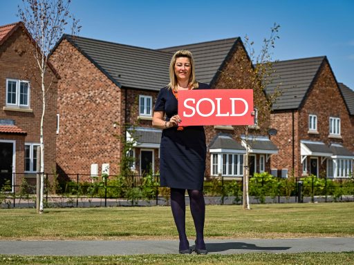 Bellway Amblers Grange sales adviser Paula showcasing the SOLD sign UNPRECENDENTED DEMAND FOR POCKLINGTON HOMES SEES BELLWAY SELL-OUT DEVELOPMENT